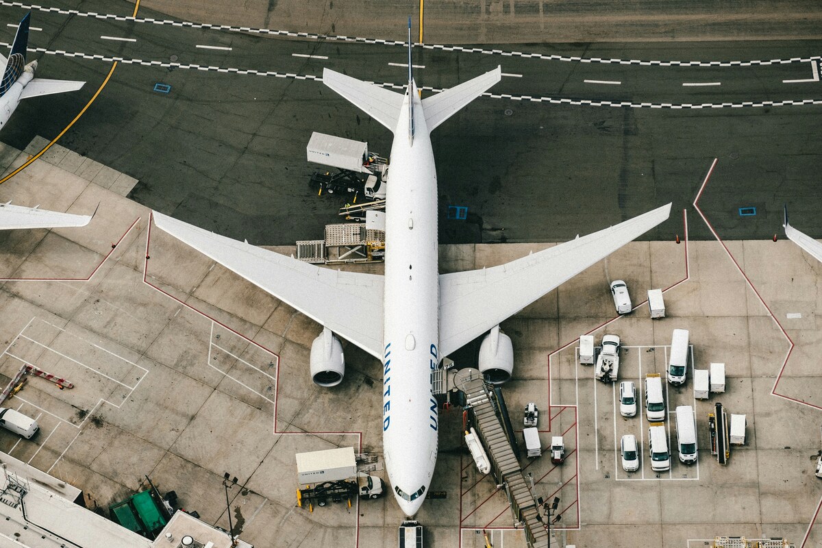 white and blue airplane on airport